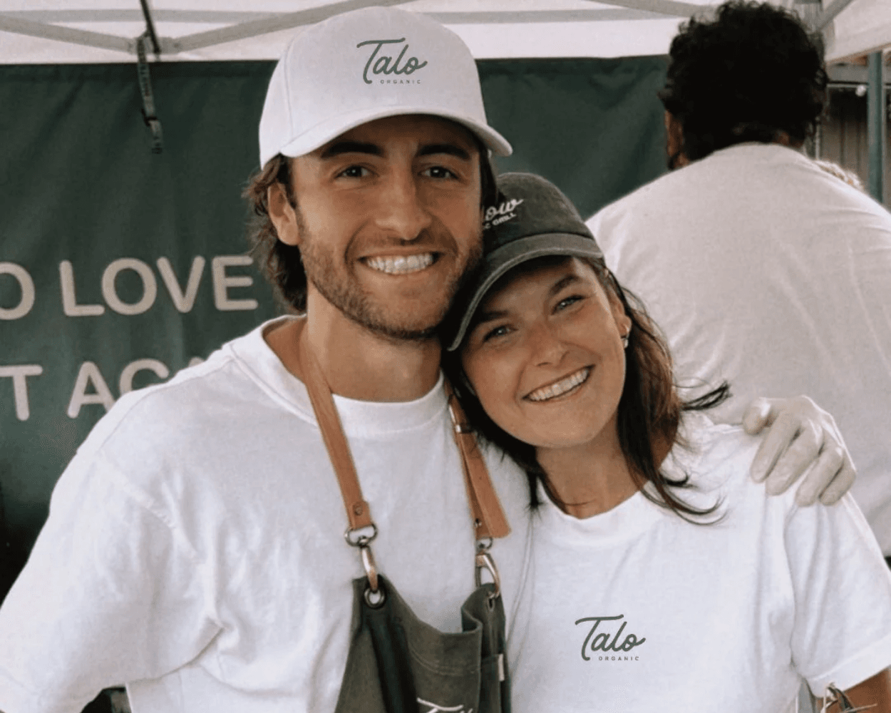 Graham and Nicole Honig wearing Talo Organic shirts at their food stand